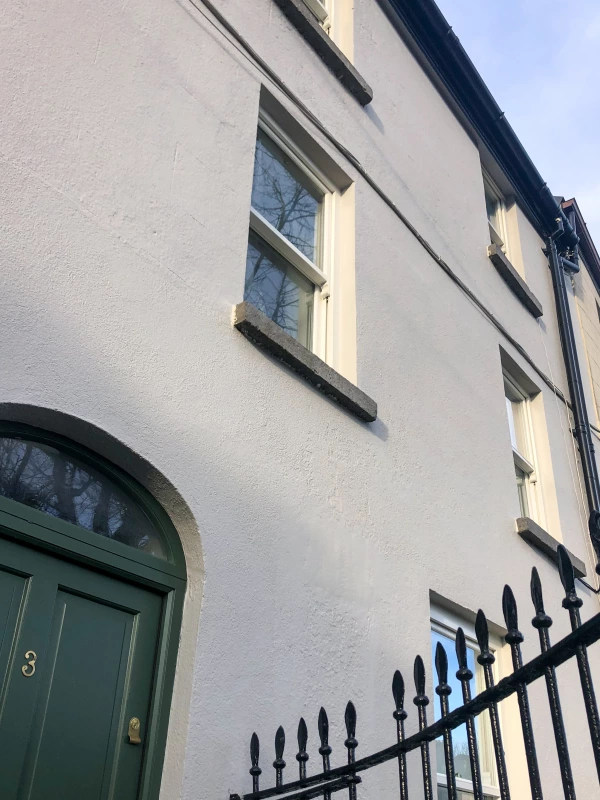 The outside wall and cast iron gates of a period townhouse in Galway